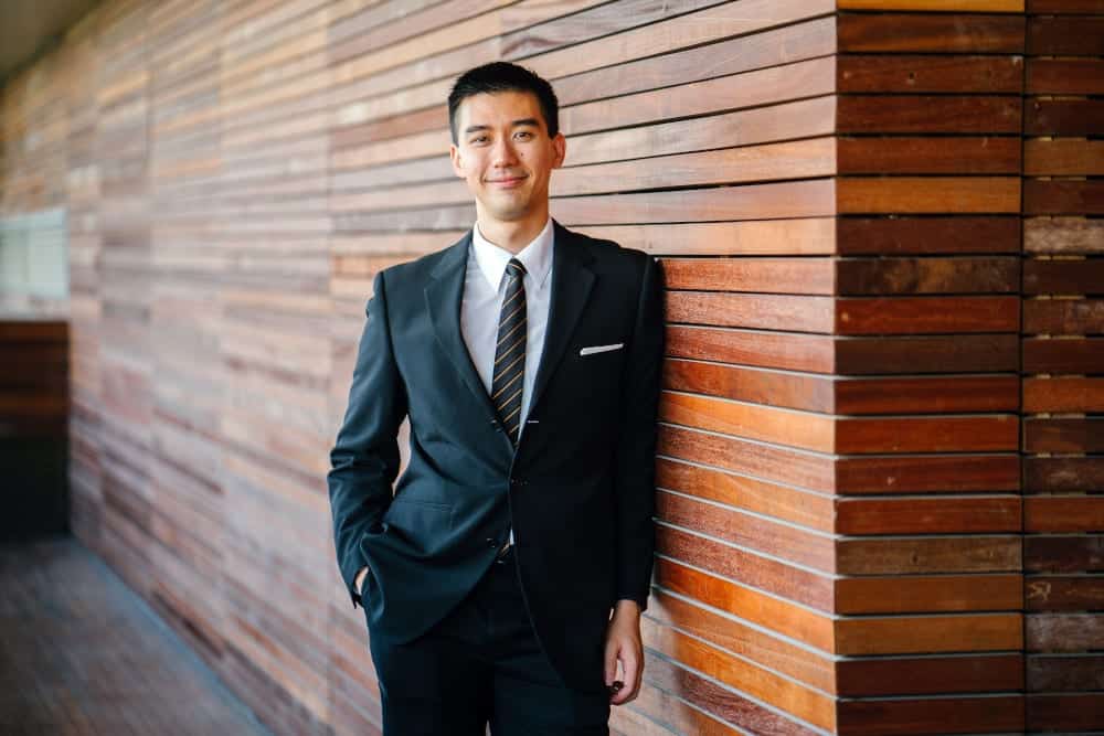 Man wearing black suit jacket and pants