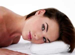 face of woman lying face down looking to her left