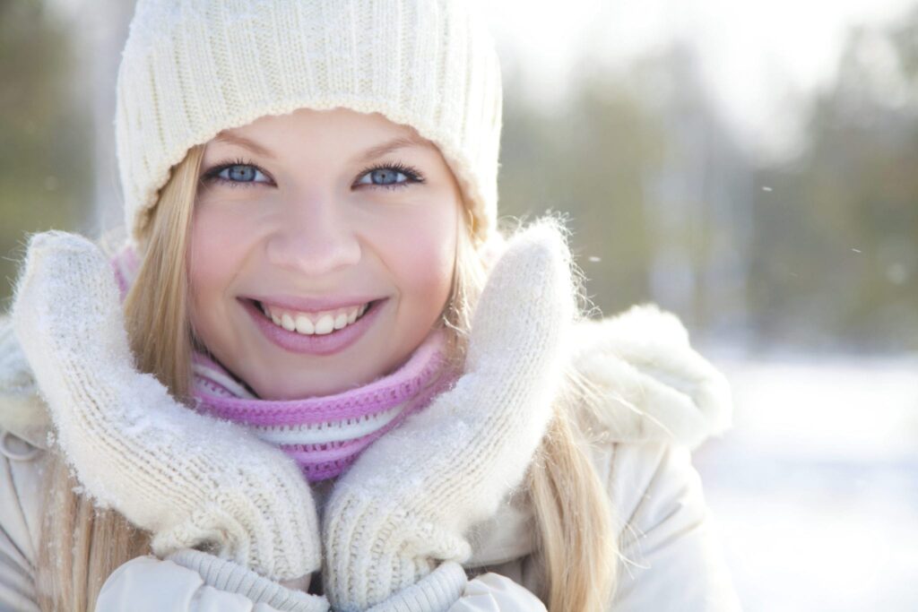 beautiful woman with white woolen cap and gloves