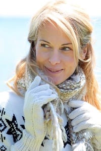 blonde smiling woman in white winter clothes