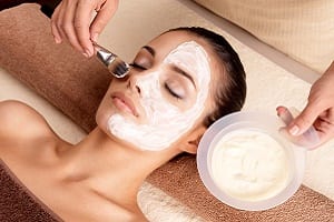 young woman receiving a face treatment 