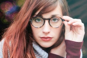 Woman with brown hair wearing eyeglasses.