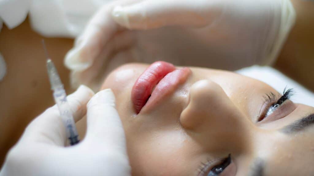 close up of a woman's face next to hands holding a syringe