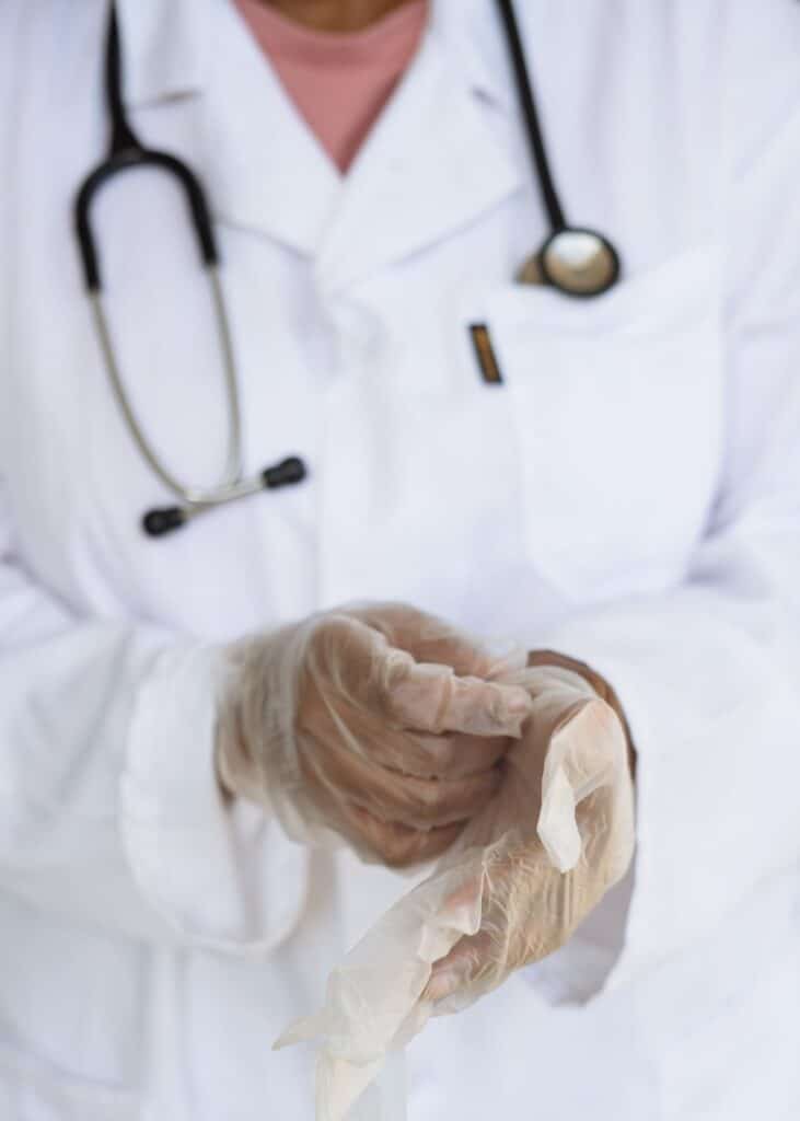 doctor putting on examination gloves