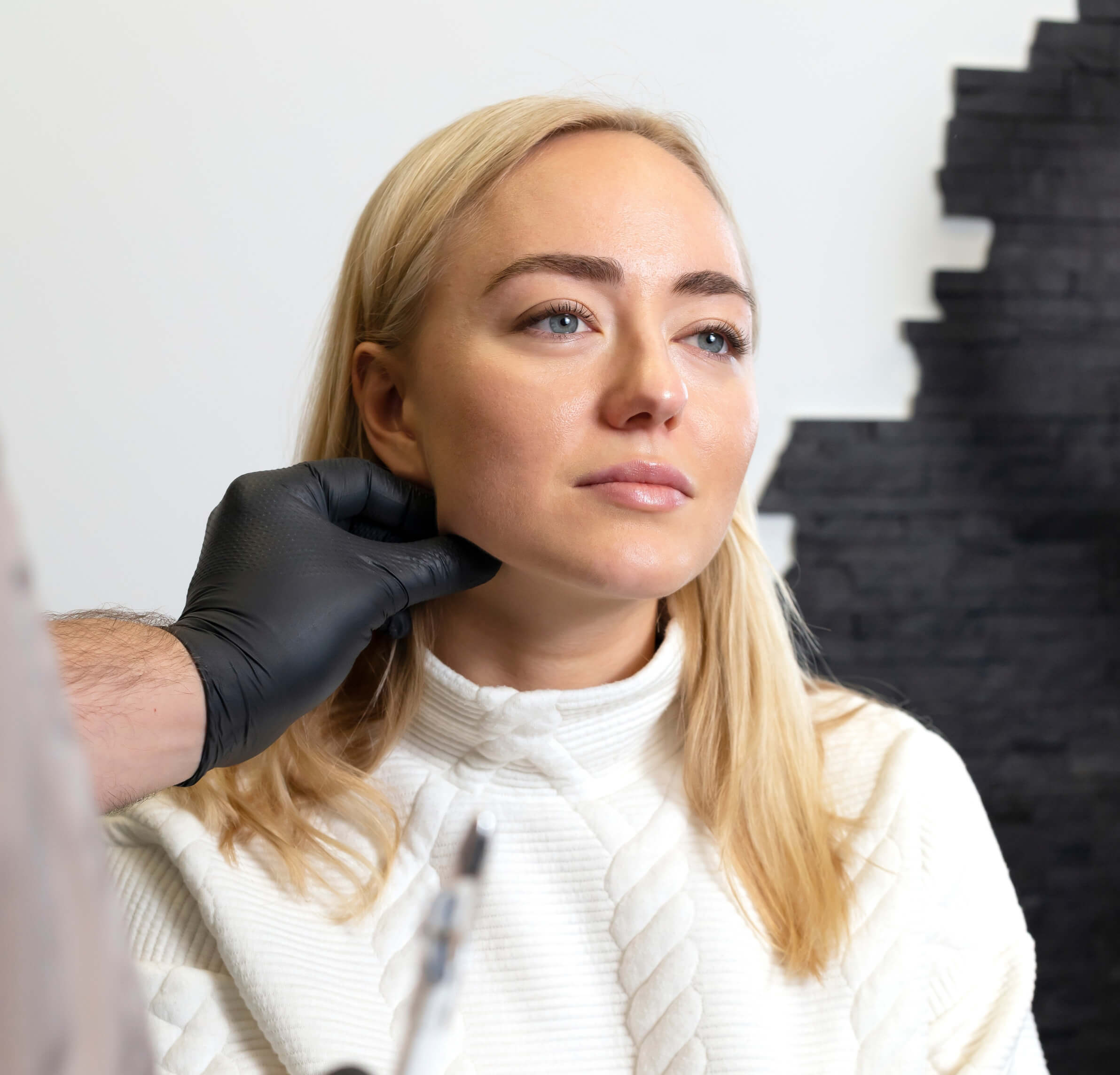 Woman getting a facial enhancement consultation