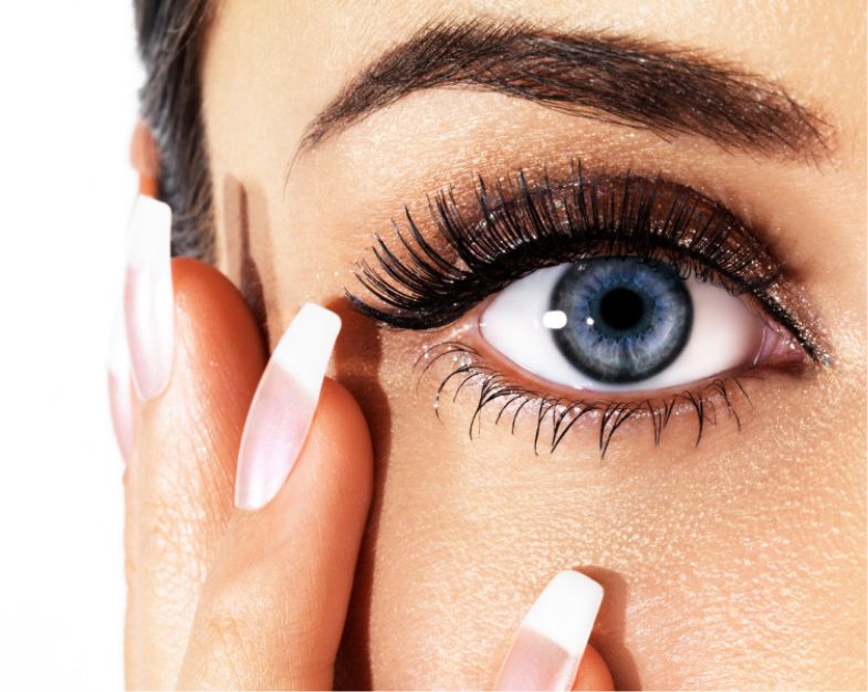 close up of a womens hit and finger nails touching her face