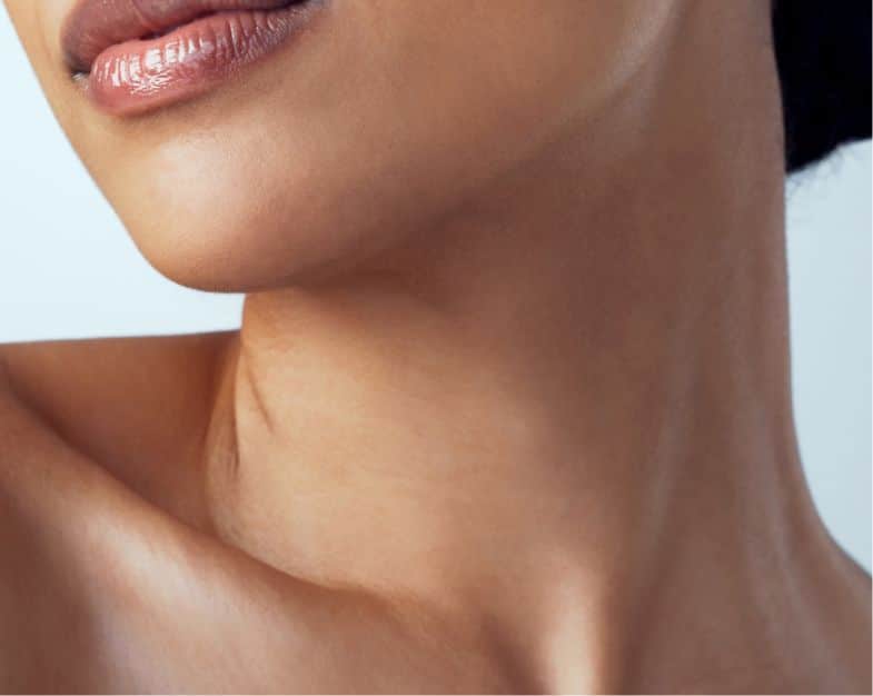 close up of darker colored skin of a womens neck and chin