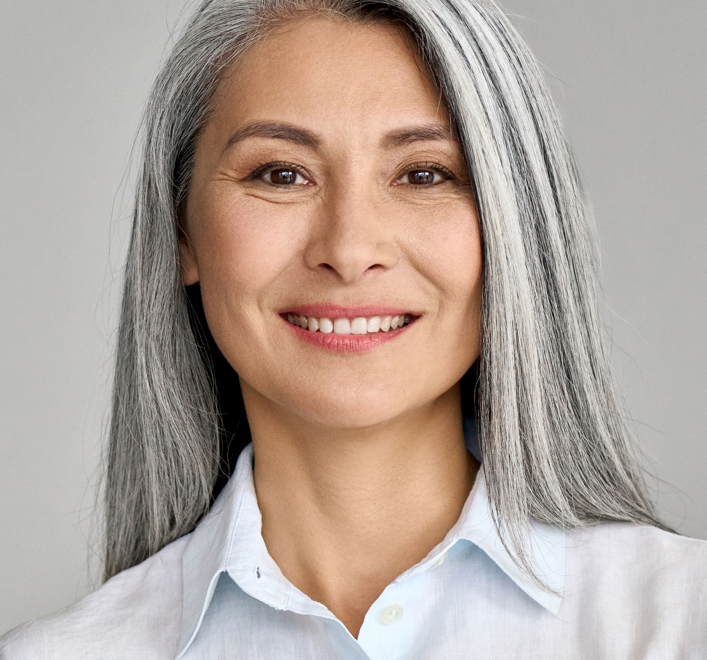 Mid age smiling women in grey hair