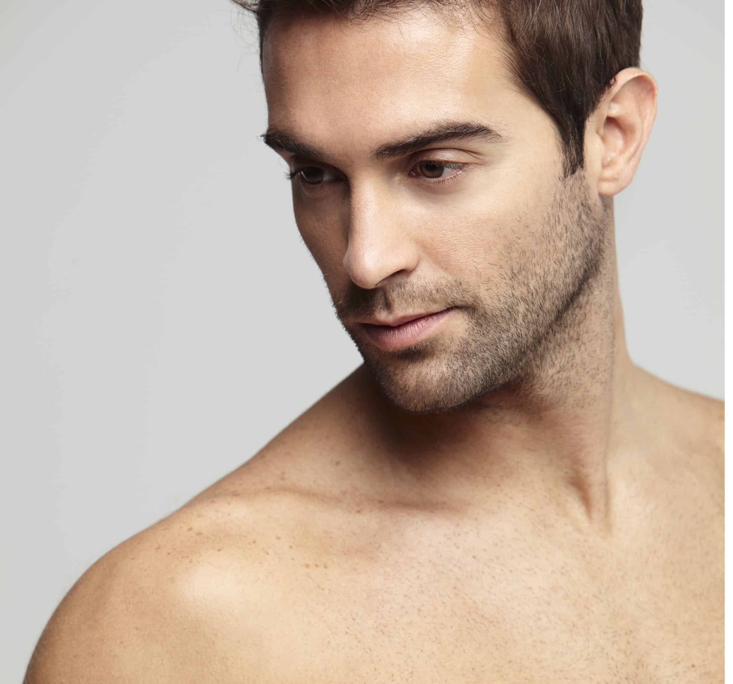 Male looking side way in grey background