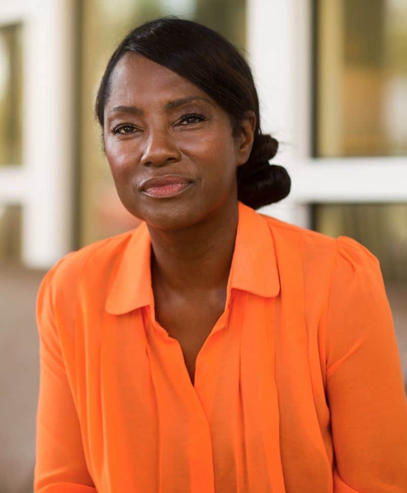 Black woman wearing a vibrant orange top