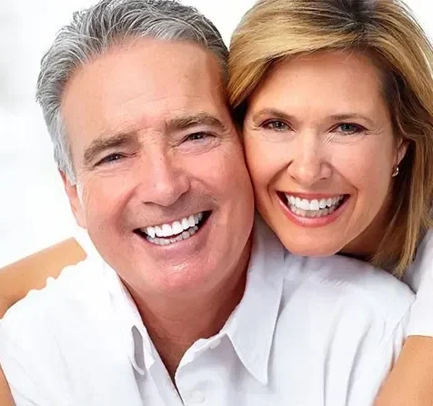 man and women smiling at the camera