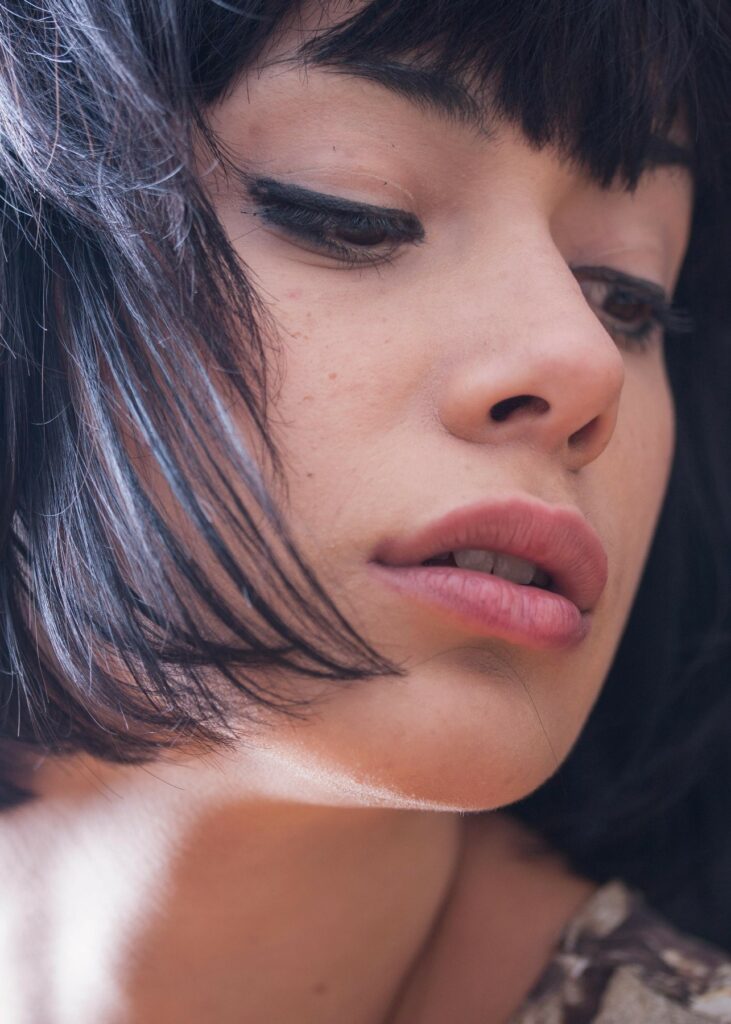 Close-up of woman with natural-looking full lips and smooth skin highlighting subtle lip enhancement results.