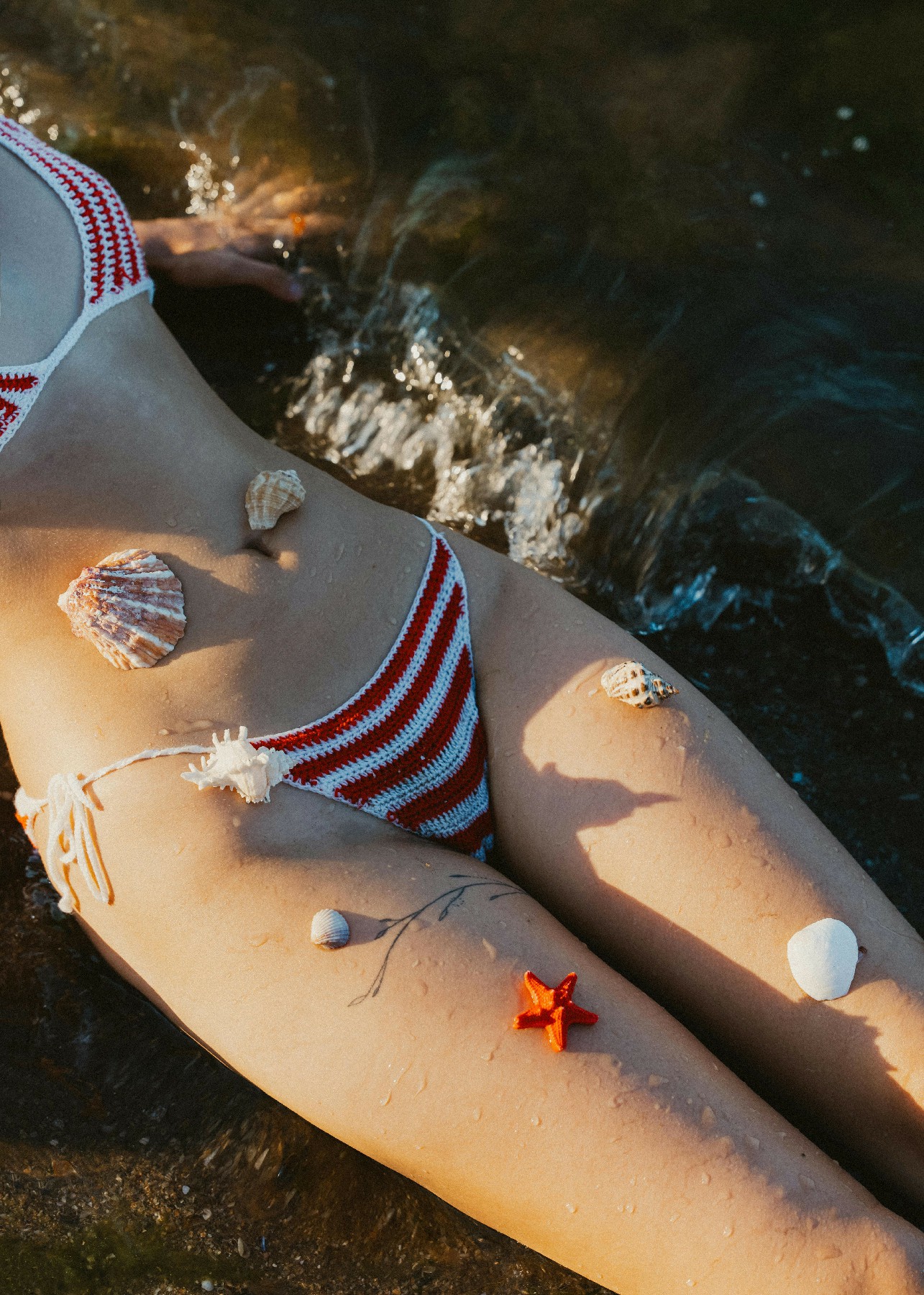 Artistic image symbolizing feminine rejuvenation and body confidence, featuring relaxed legs by the water in a serene, natural setting.