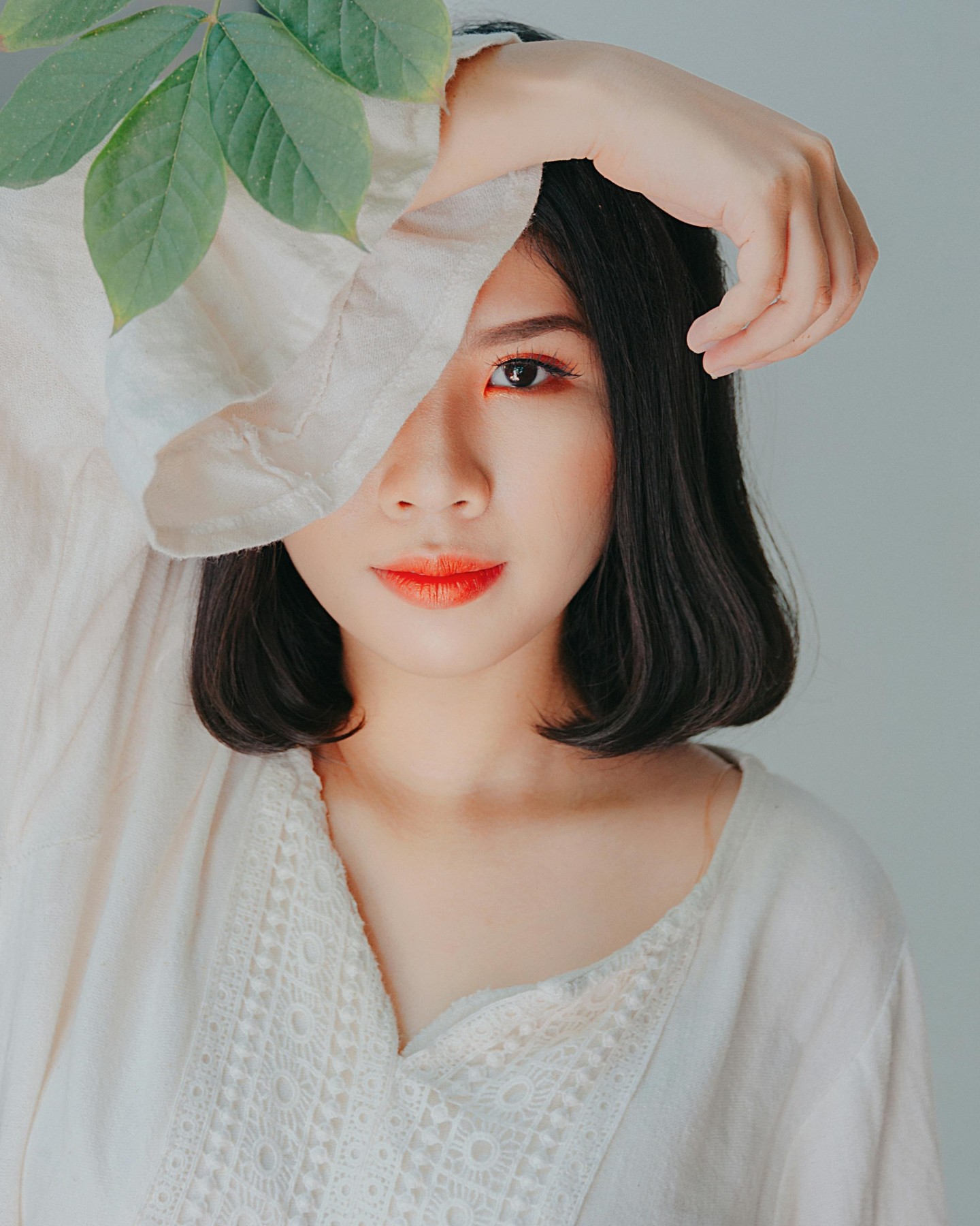 Woman with smooth, radiant skin and soft makeup posing under natural light, symbolizing refreshed beauty from aesthetic treatments.